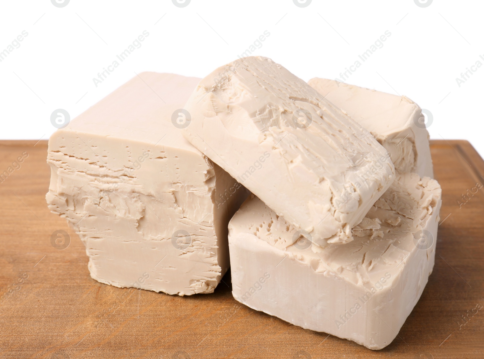 Photo of Pieces of compressed yeast on white background, closeup