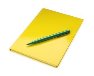 New yellow planner and pen isolated on white
