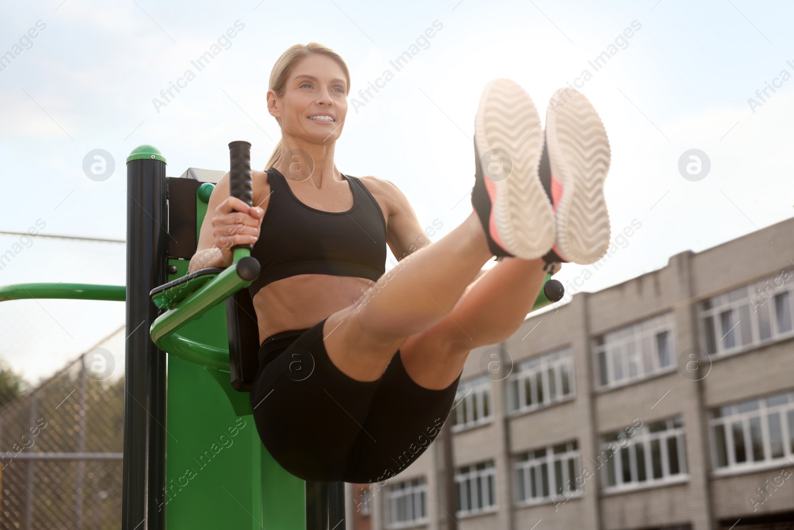 Photo of Woman training on abs station at outdoor gym