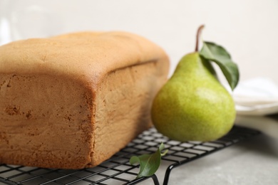 Tasty bread and pear on light grey table, closeup. Homemade cake