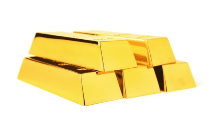 Photo of Precious shiny gold bars on white background