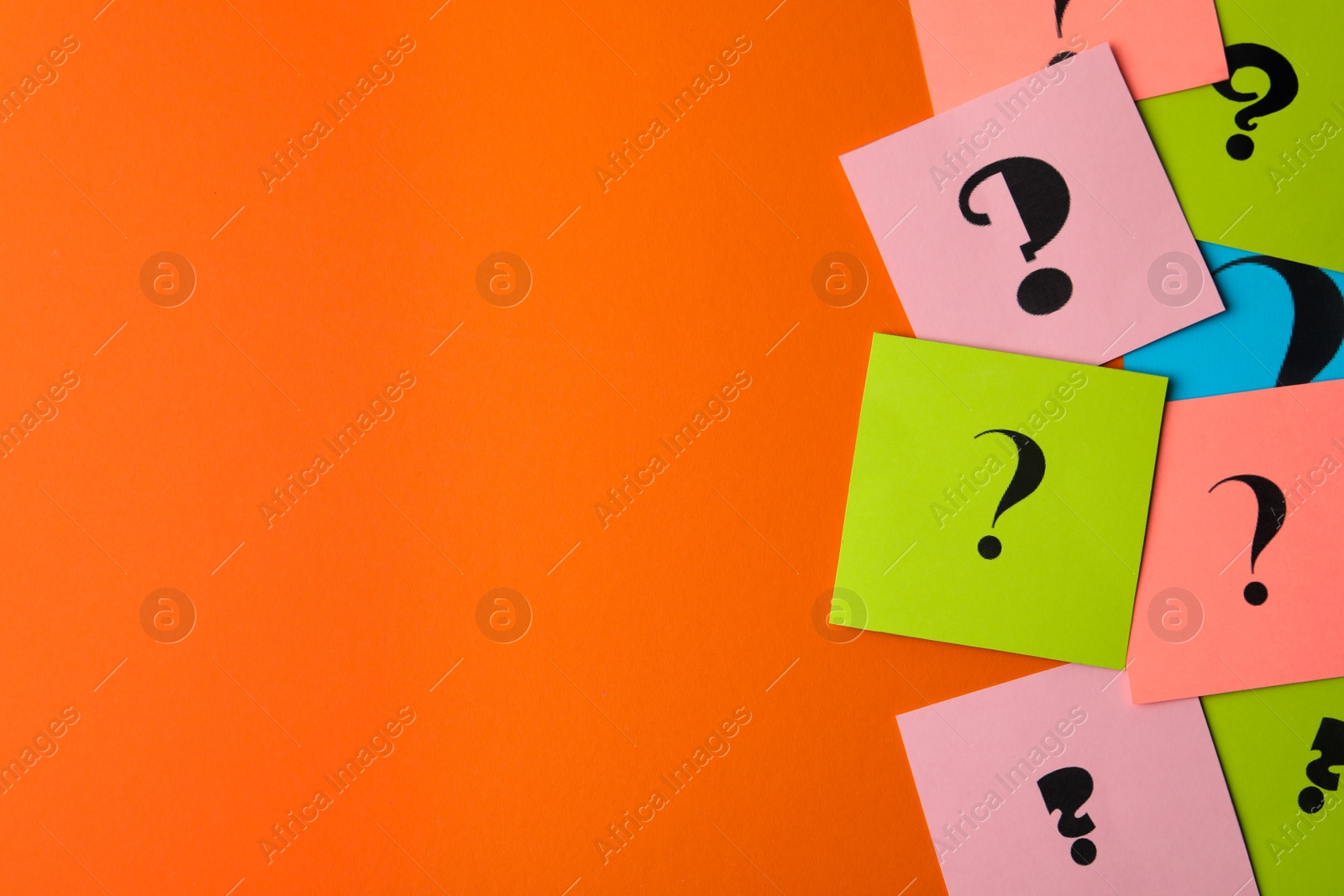 Photo of Paper cards with question marks on orange background, flat lay. Space for text