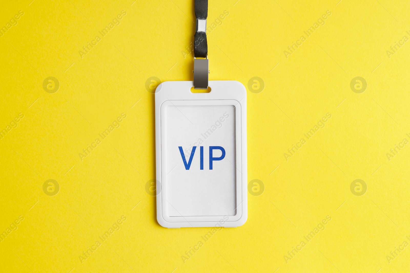 Photo of Vip badge on yellow background, top view