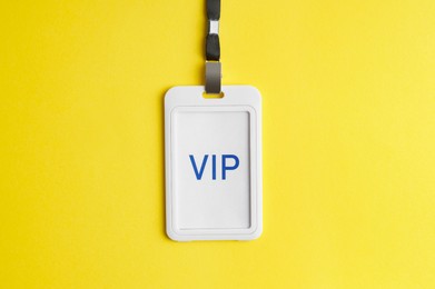 Photo of Vip badge on yellow background, top view