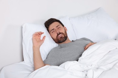 Photo of Man sleeping on comfortable pillows in bed at home