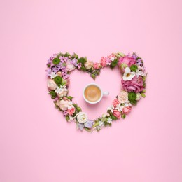 Photo of Beautiful heart made of different flowers and coffee on pink background, flat lay