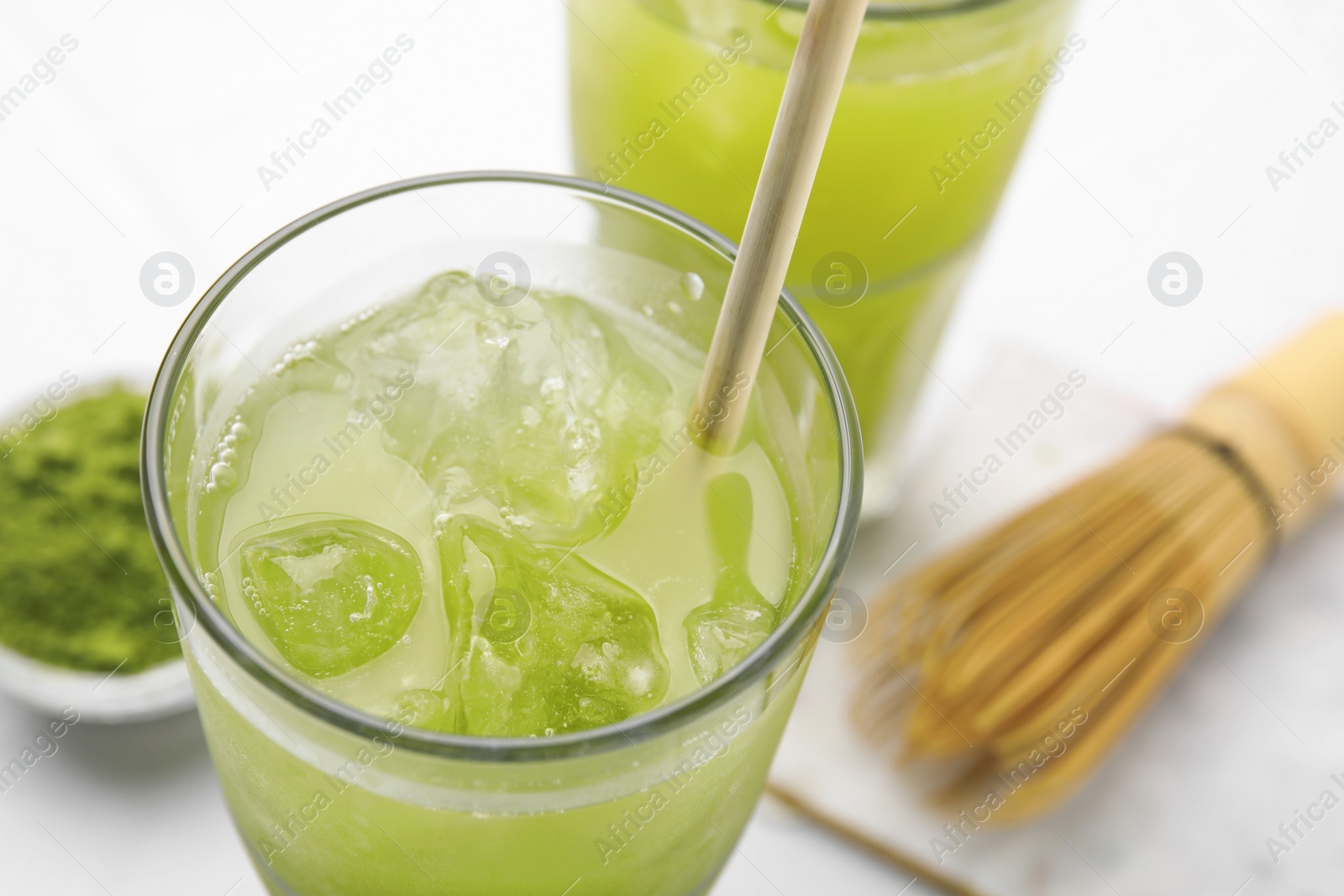 Photo of Glass of delicious iced green matcha tea, closeup