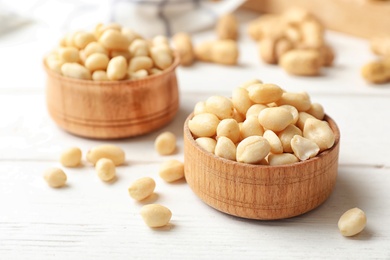 Shelled peanuts in wooden bowls on table