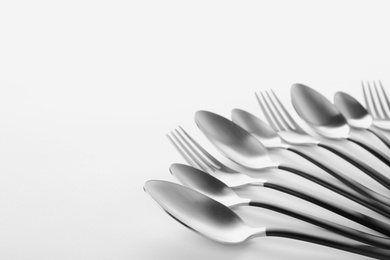 Photo of Forks and spoons on white background. New cutlery