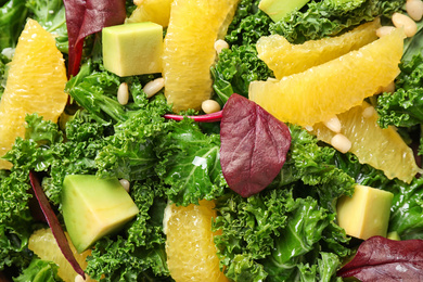 Photo of Tasty fresh kale salad as background, closeup