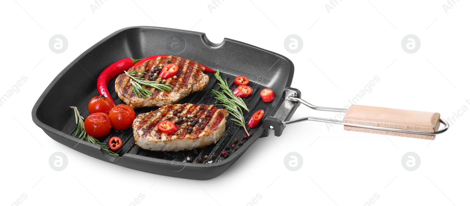 Photo of Grill pan with delicious pork steaks, spices and vegetables isolated on white