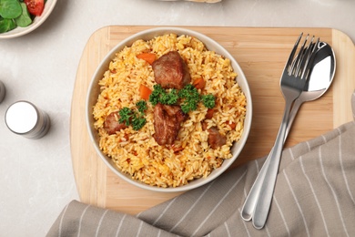 Rice pilaf with meat served on table, top view