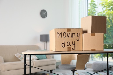 Cardboard boxes on table against blurred background. Moving day