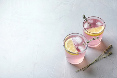 Photo of Natural lemonade with lavender in glasses on light background