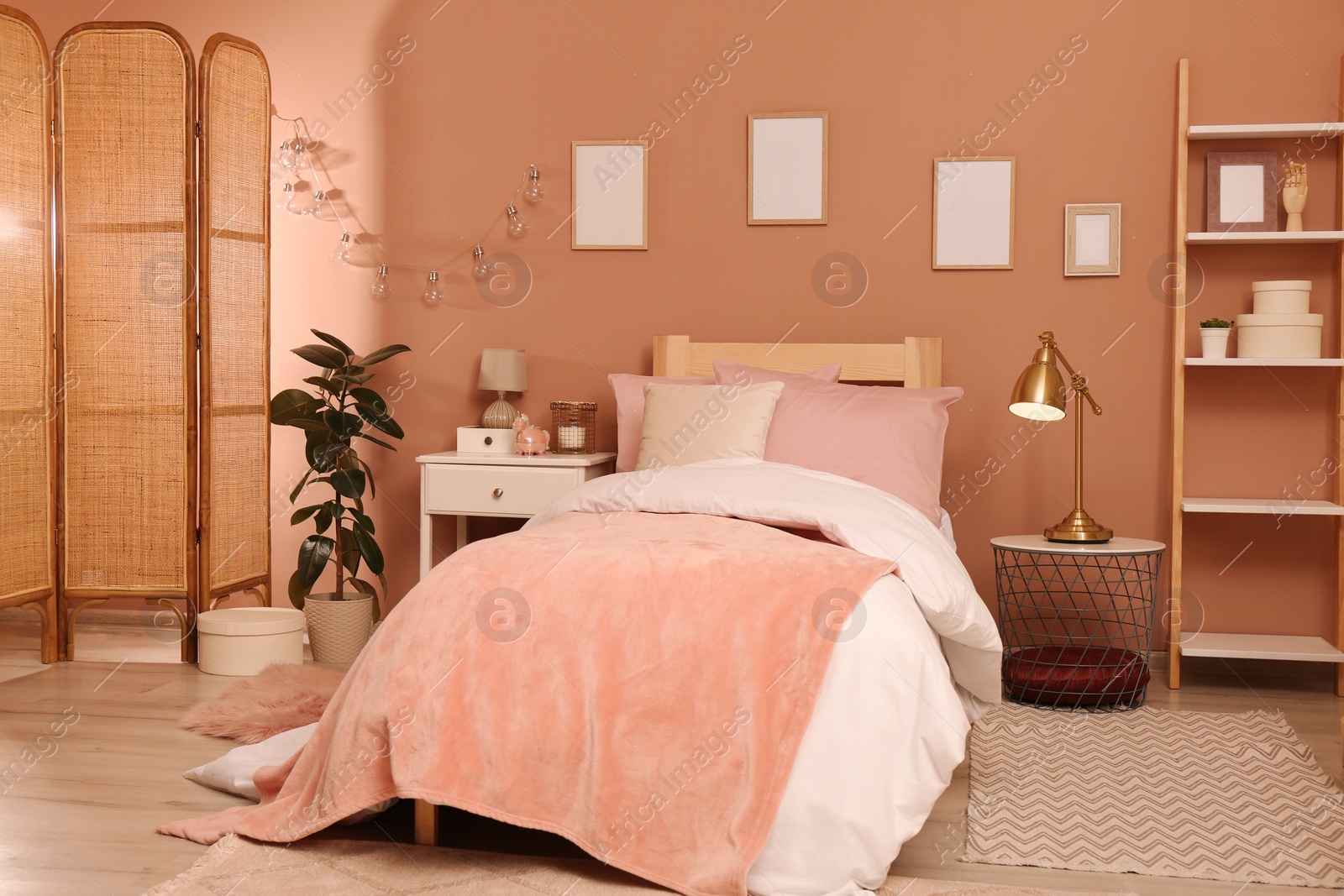 Photo of Teenage girl's bedroom interior with stylish furniture and beautiful decor elements