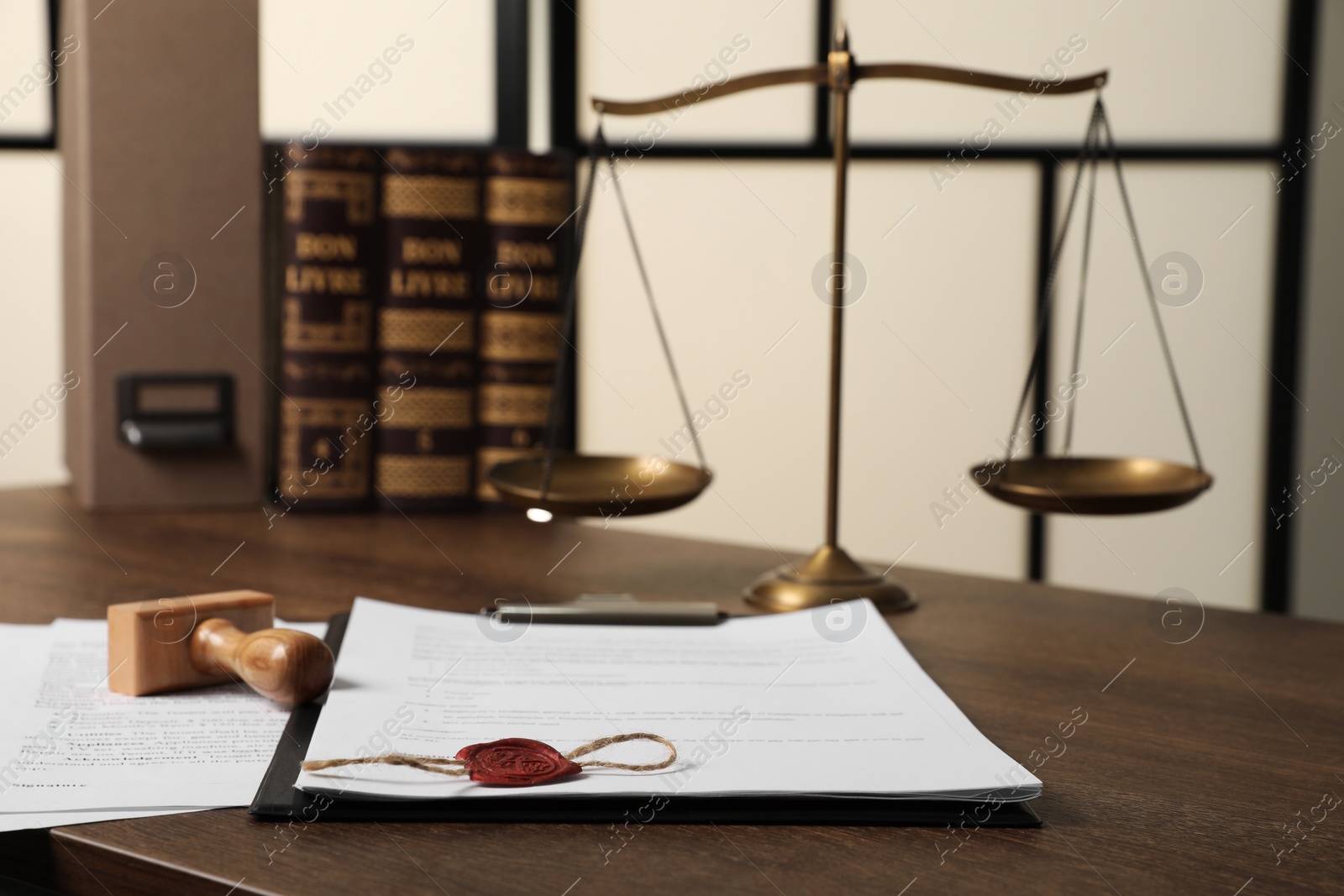 Photo of Documents and stamp on wooden table, closeup. Notary contract