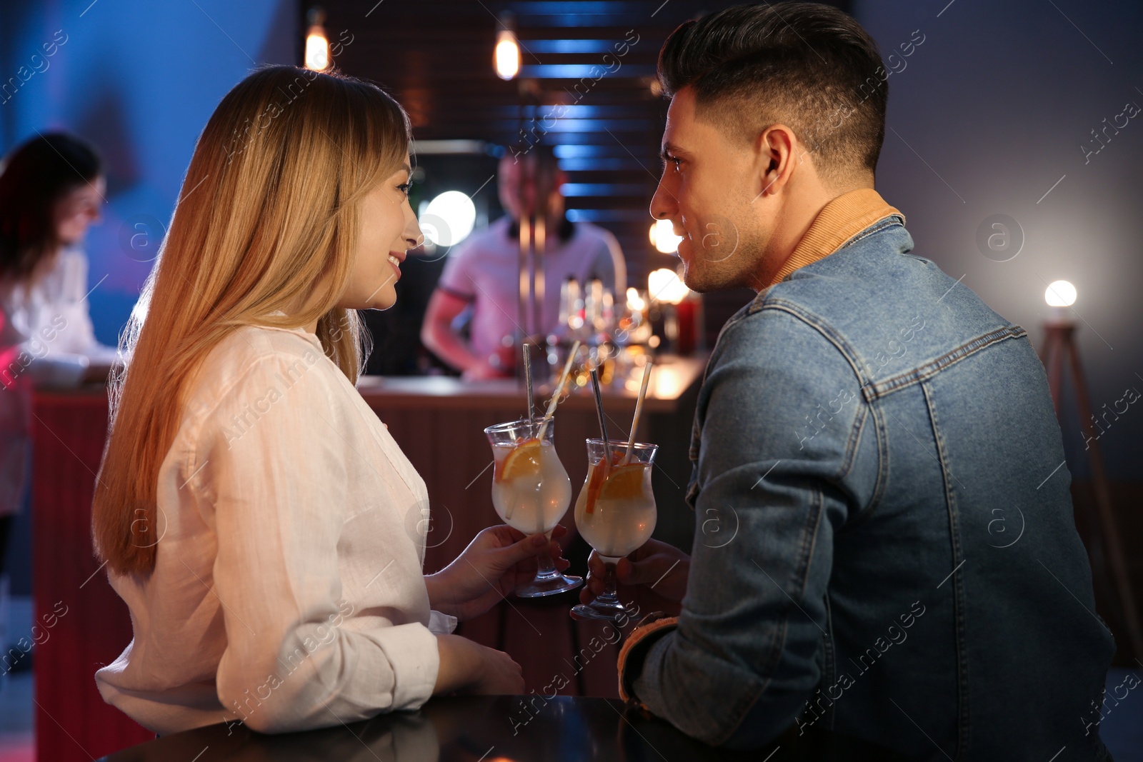 Photo of Man and woman flirting with each other in bar