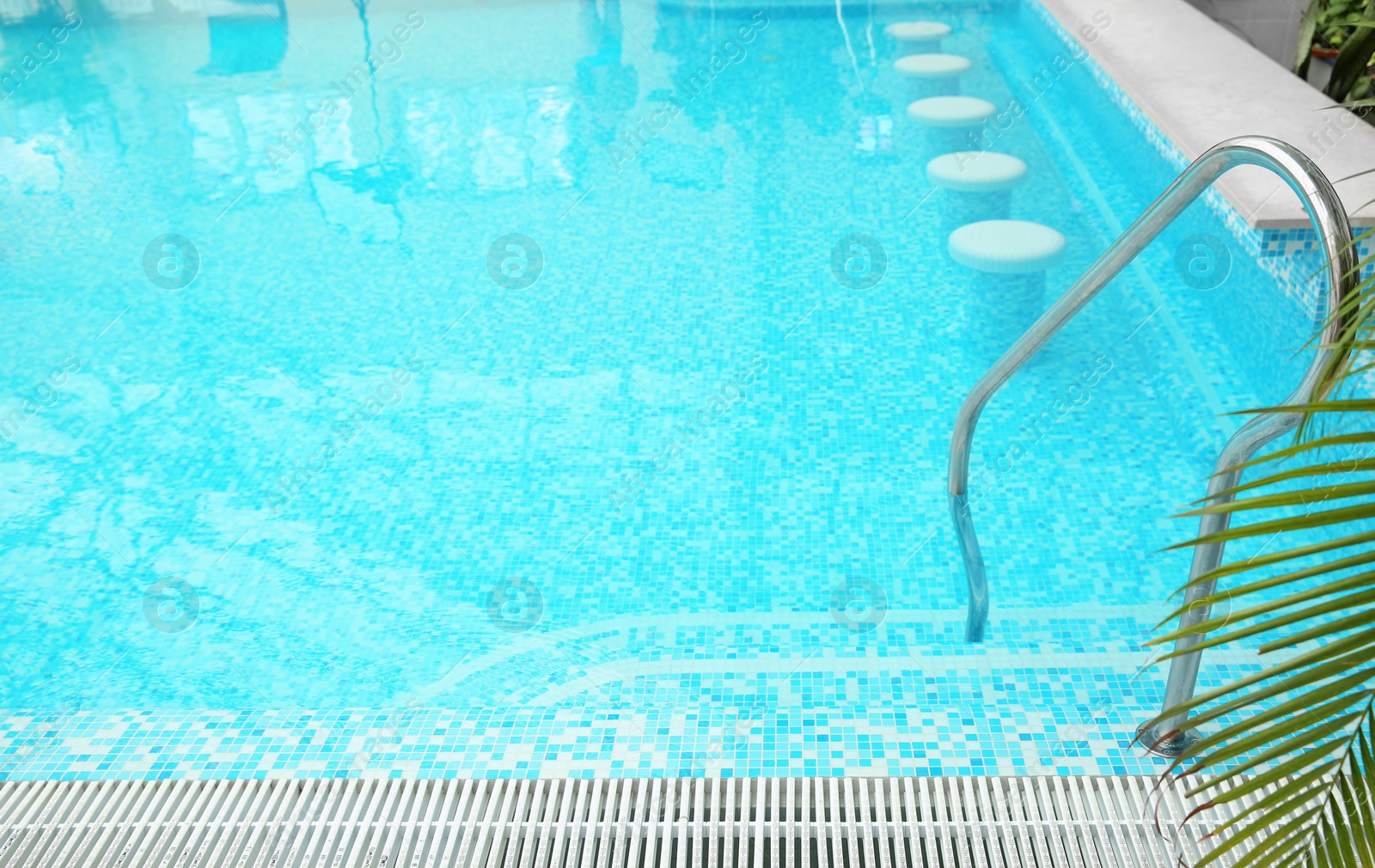 Photo of Swimming pool with refreshing blue water. Time to relax