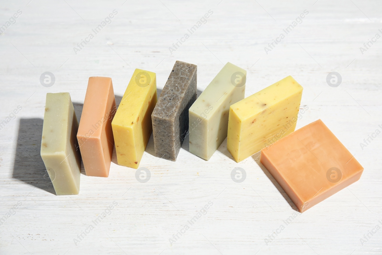 Photo of Hand made soap bars on white wooden background