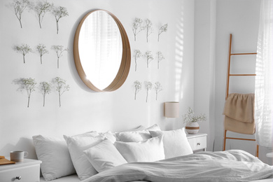 Photo of Modern bedroom interior with stylish round mirror