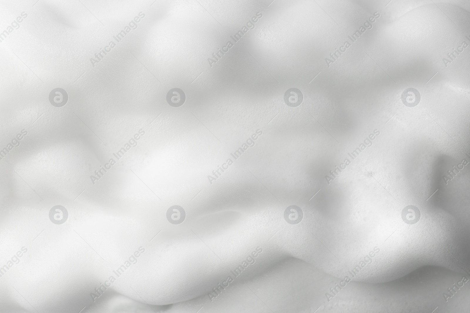 Photo of Foam as background, closeup. Face cleanser, skin care cosmetic