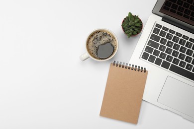 Photo of Modern laptop, notebook, houseplant and cup of coffee on white background, flat lay. Space for text