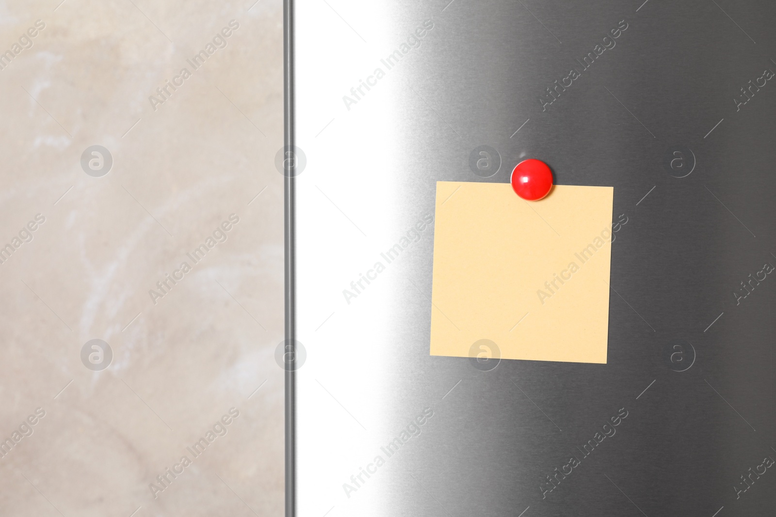 Photo of Blank note with magnet on refrigerator door. Space for text