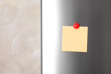 Photo of Blank note with magnet on refrigerator door. Space for text