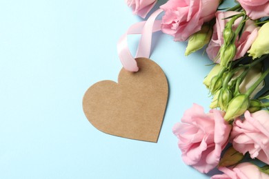 Photo of Happy Mother's Day. Beautiful flowers with blank heart shaped card on light blue background, flat lay