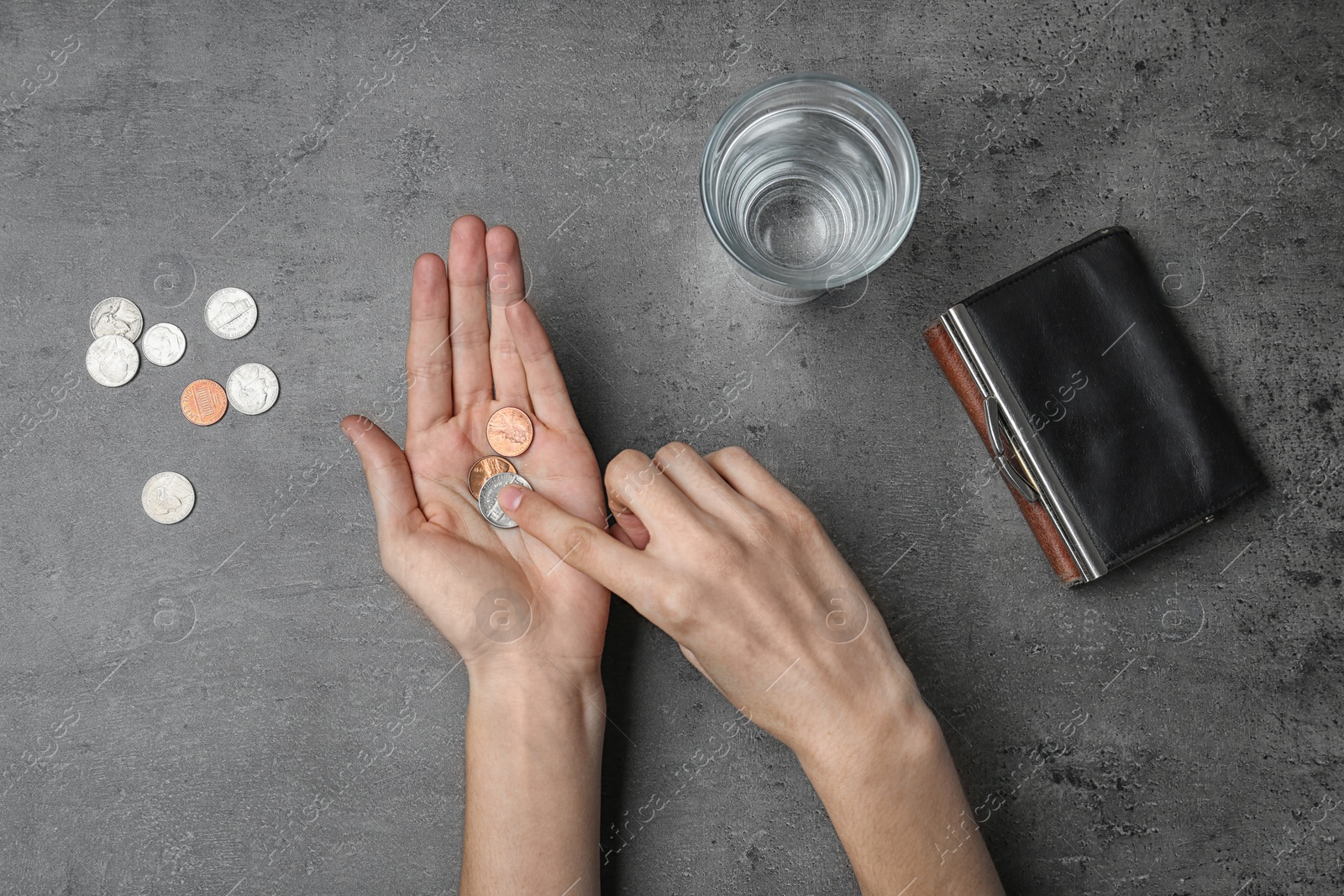 Photo of Poor woman counting coins on grey background, top view