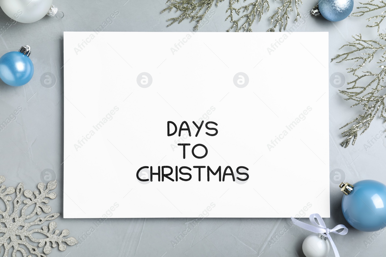 Photo of Flat lay composition of card with words Days To Christmas and space for text on light grey stone table. Holiday countdown