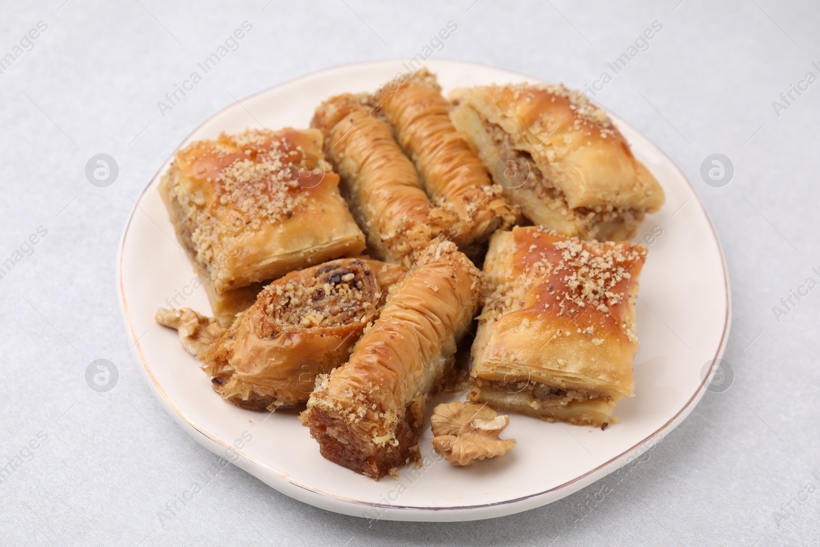 Photo of Eastern sweets. Pieces of tasty baklava on white table