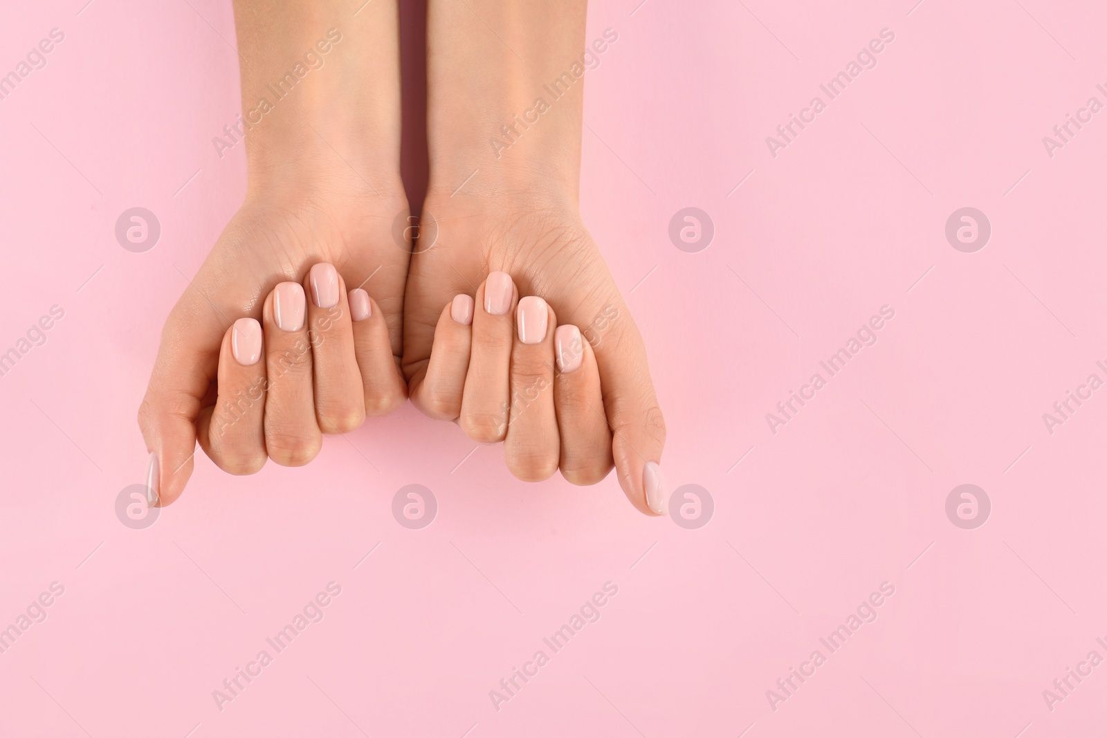 Photo of Closeup view of woman with beautiful hands on color background, space for text. Spa treatment