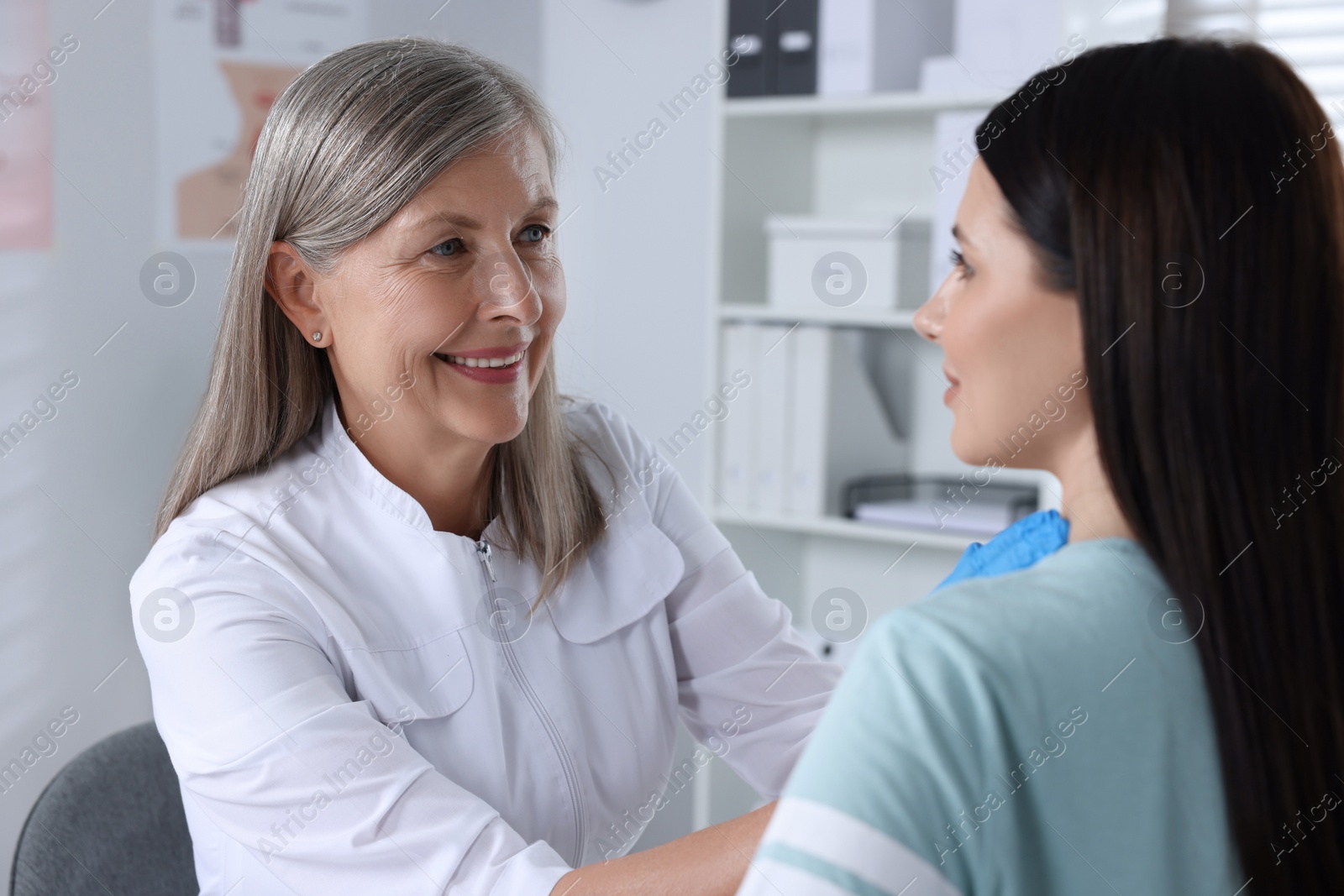 Photo of Endocrinologist examining thyroid gland of patient at hospital