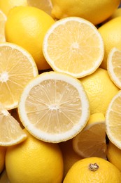 Photo of Many fresh ripe lemons as background, closeup