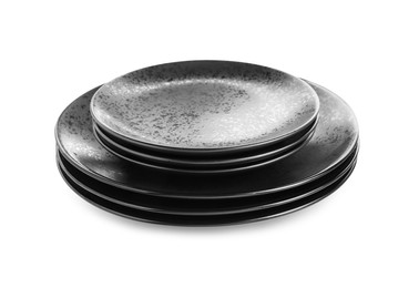 Photo of Stack of black ceramic plates isolated on white