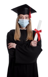 Student in protective mask with diploma on white background