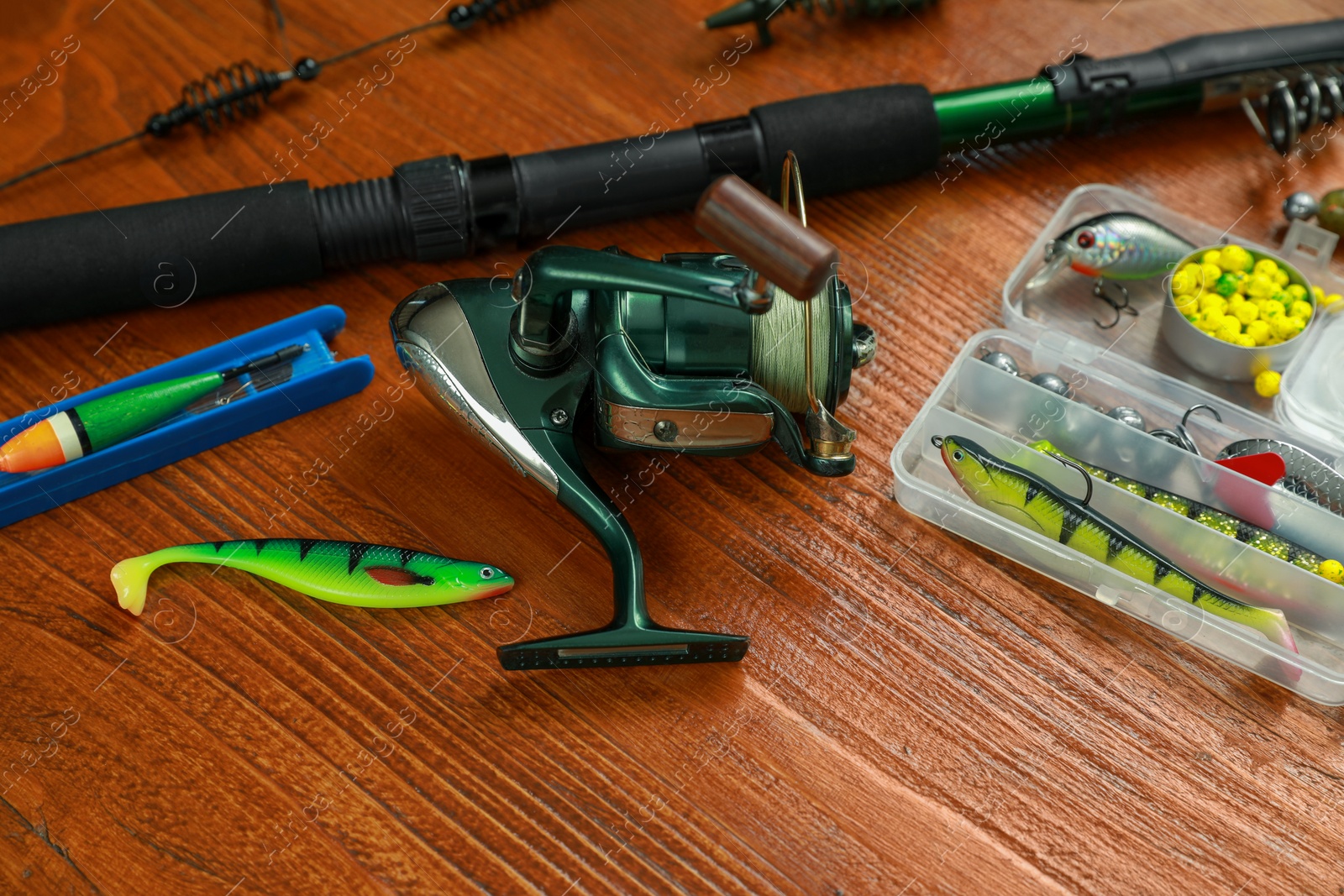 Photo of Fishing tackle on wooden table, closeup view