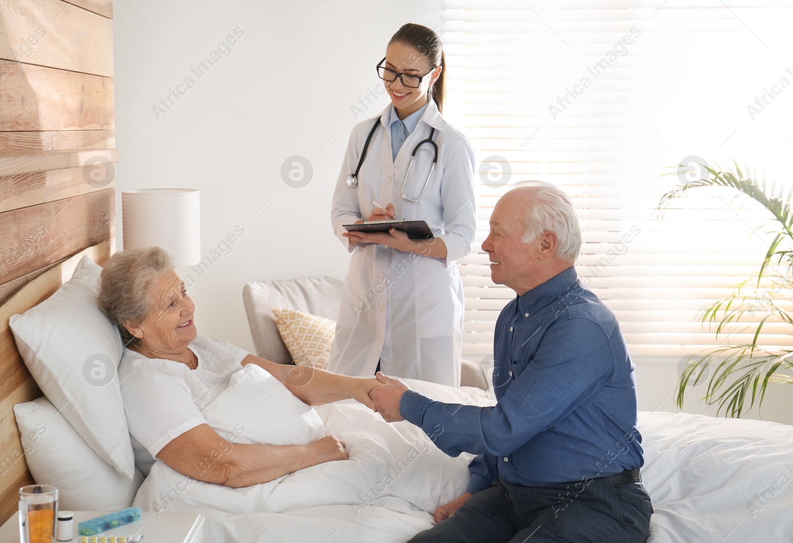 Photo of Senior couple and doctor in modern hospital