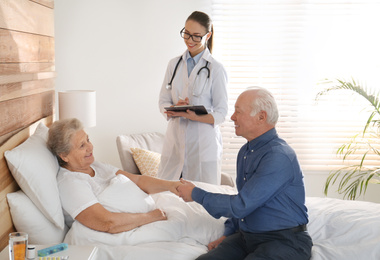 Senior couple and doctor in modern hospital