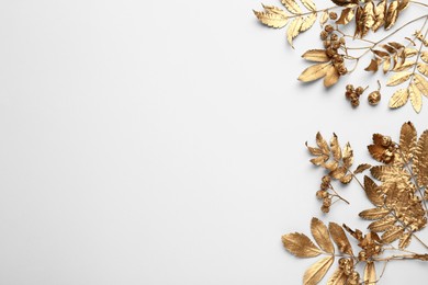 Golden rowan leaves and berries on white background, flat lay with space for text. Autumn season