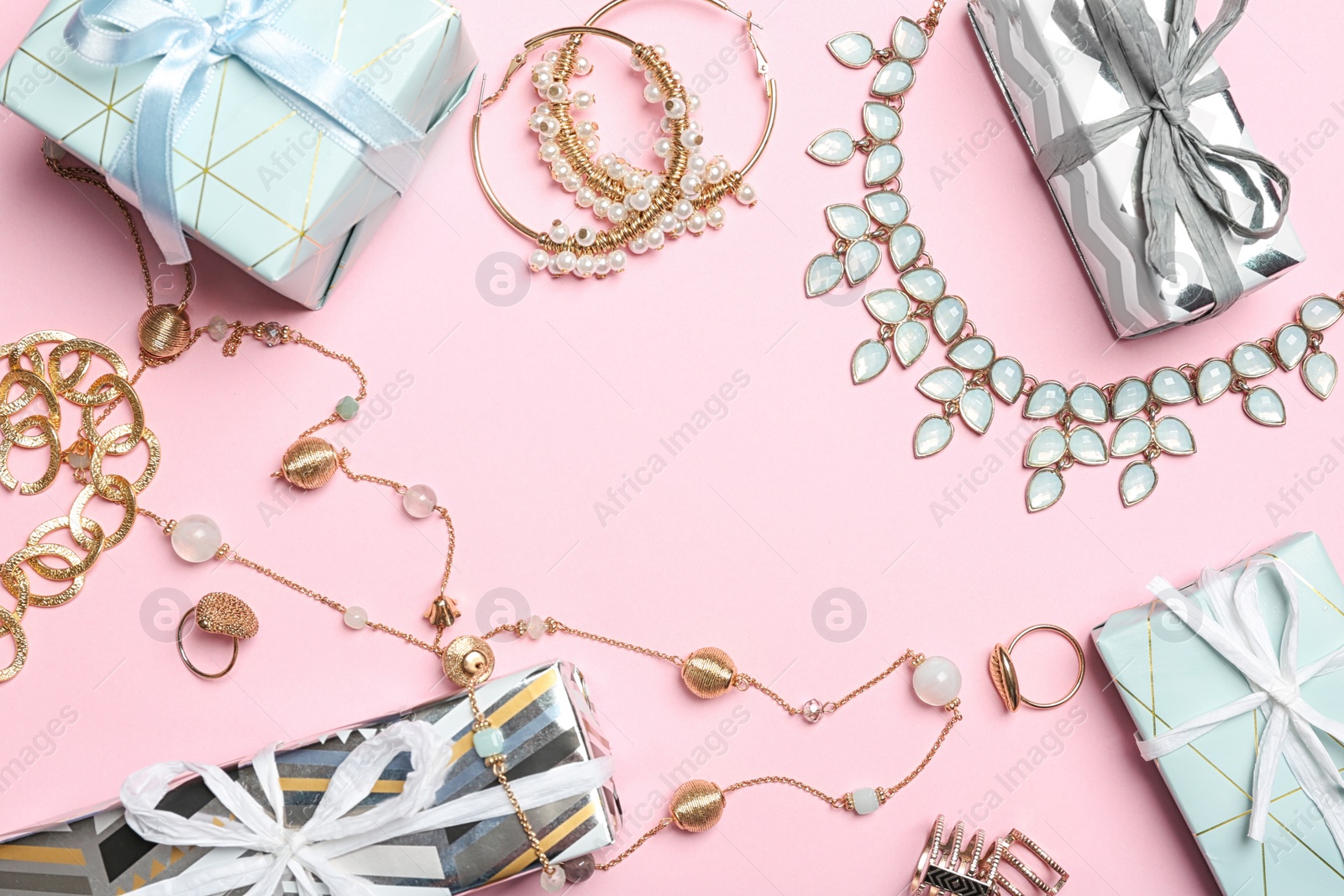 Photo of Beautiful jewelry and gift boxes on color background, flat lay. Space for text