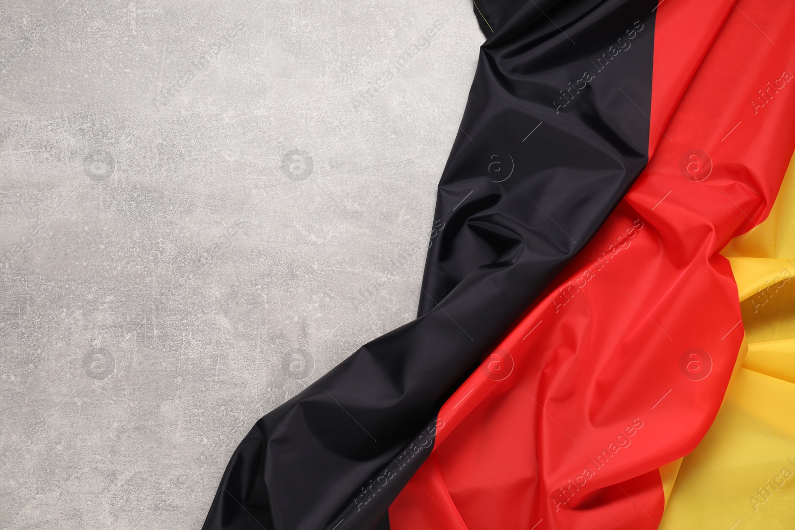 Photo of Flag of Germany on light gray textured background, top view. Space for text