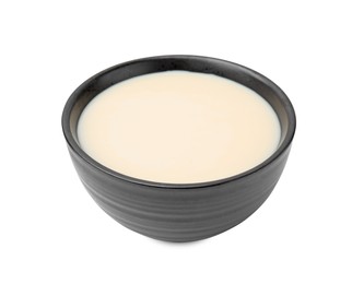 Bowl with condensed milk isolated on white