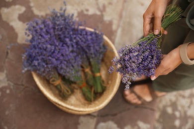 Photo of Woman with beautiful lavender flowers outdoors, closeup. Space for text