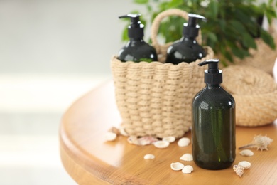 Photo of Soap dispensers and wicker basket on wooden table. Space for text