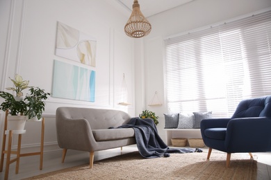 Photo of Beautiful living room interior with comfortable gray sofa