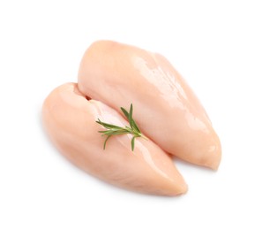 Raw chicken breasts with rosemary on white background, top view
