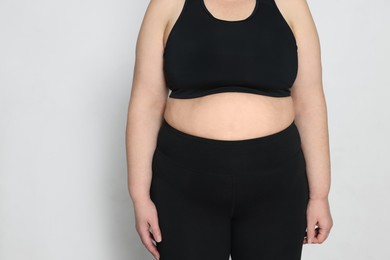 Photo of Obese woman on white background, closeup with space for text. Weight loss surgery
