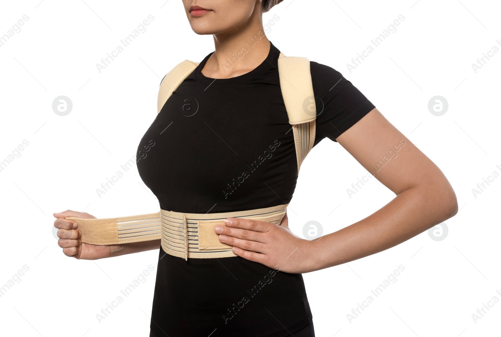 Photo of Closeup view of woman with orthopedic corset on white background